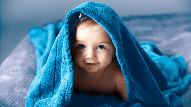 Baby boy covered in a blue blanket